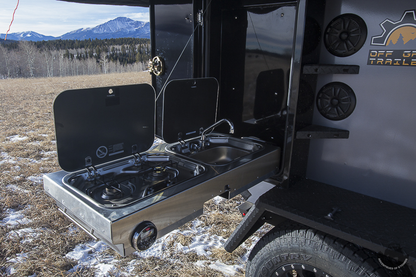 Off Grid Trailers Expedition 2.0 fold down side kitchen.  Includes sink and two burner stove.